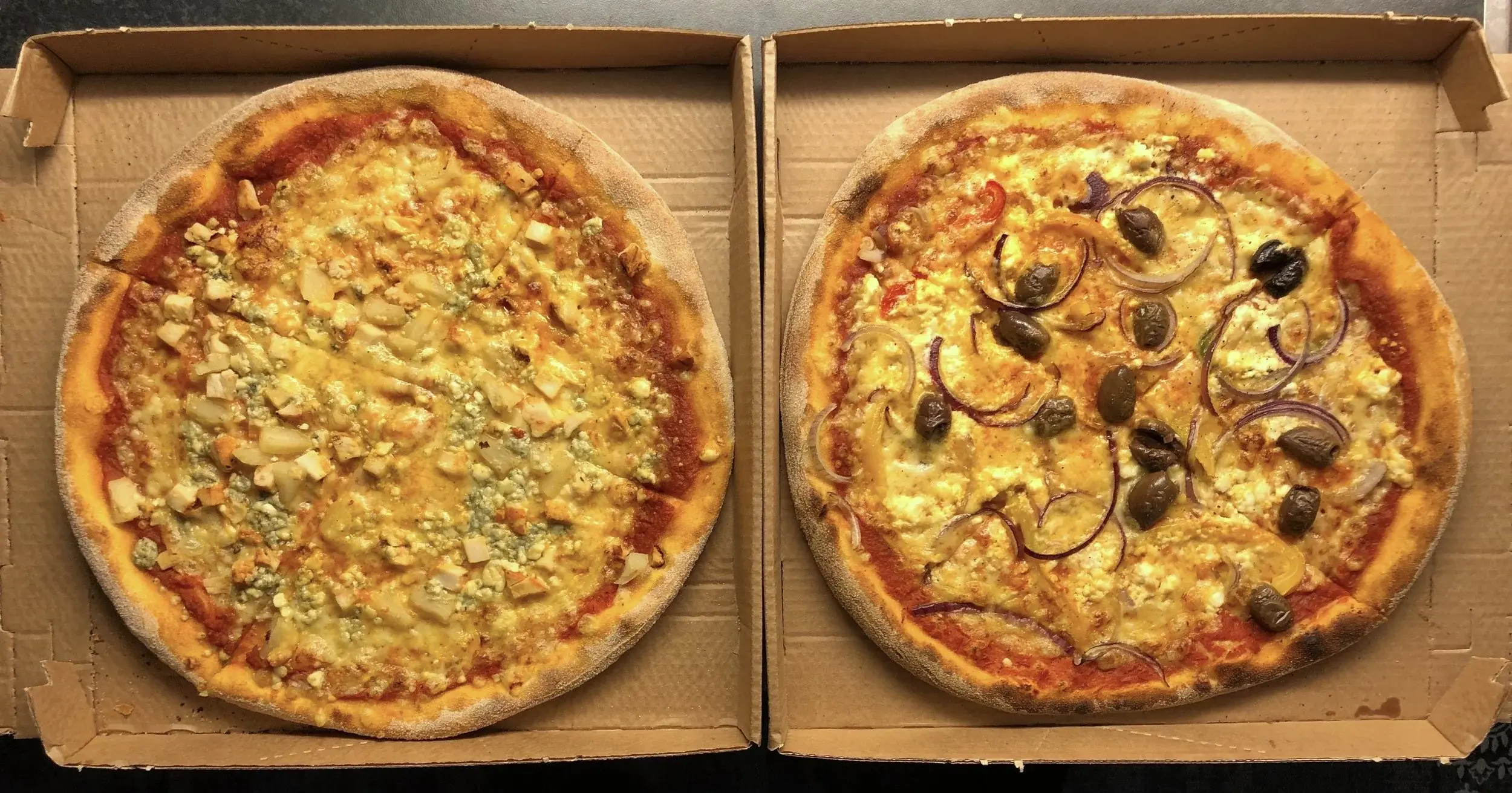 Two average-size pizzas in Finland on a table
